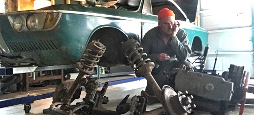 author posing with BMW 2000c engine and suspension removed from car